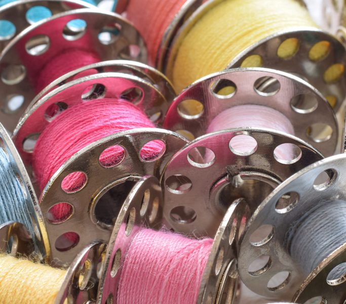 Macro closeup colorful sewing thread bobbins